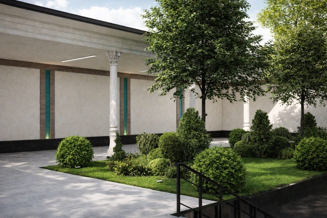 The covered walkway of carved columns along the Academy courtyard, with turquoise tile set into the wall behind.